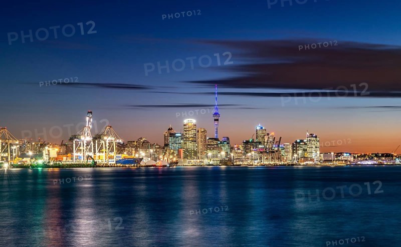 Illuminated skyline of Auckland at sunset