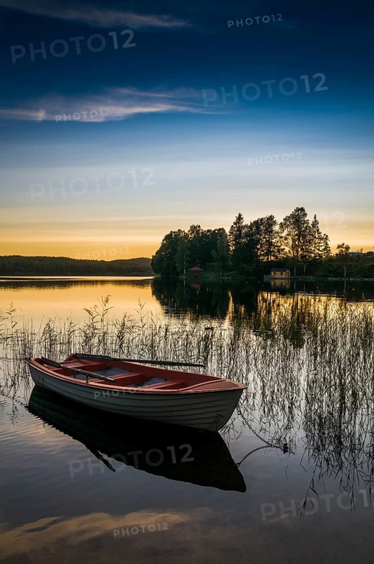 Lake and rowing boat at sunset in Bengtsfors