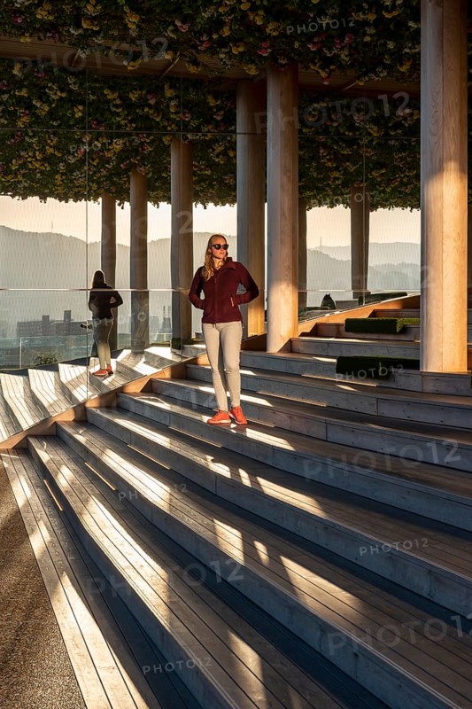 Young woman standing on stairs on panoramic roof