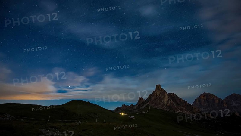 Gusela mountain in a starry night with clouds