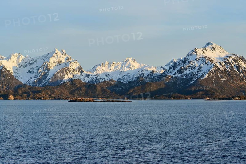 Snow-covered mountains on Hadselfjord in the evening light