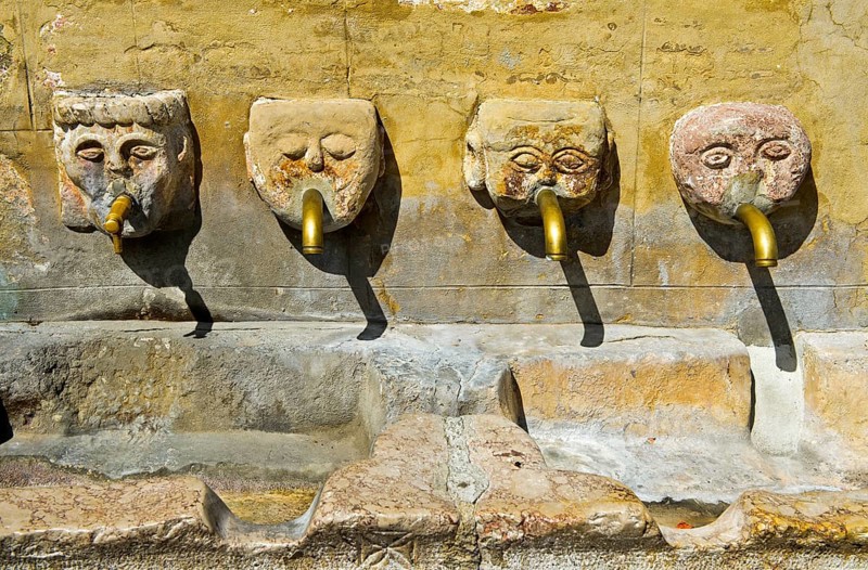 Four gargoyles by the village well