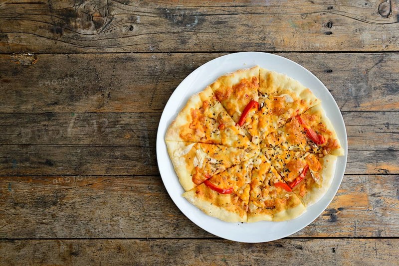 Kiln baked pizza on wooden table