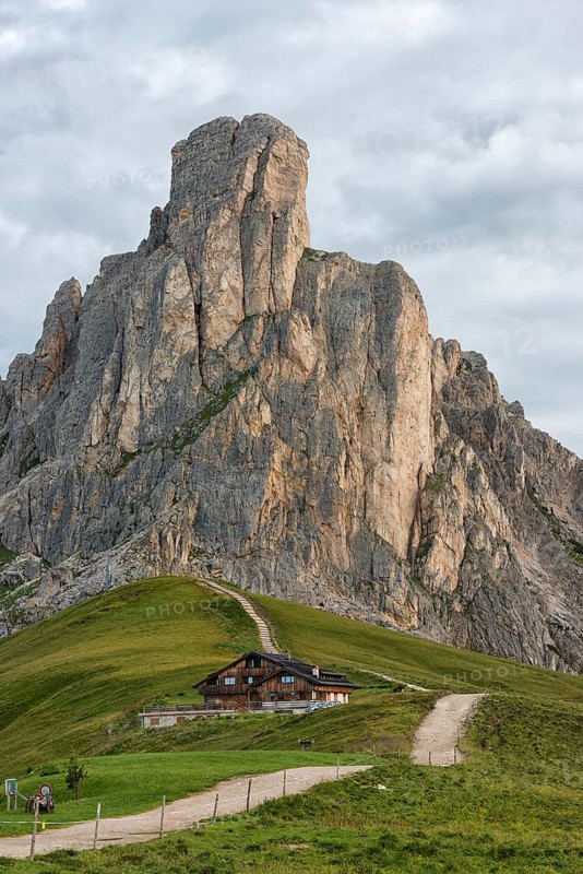 Mountain hut and mount Gusela on a cloudy day