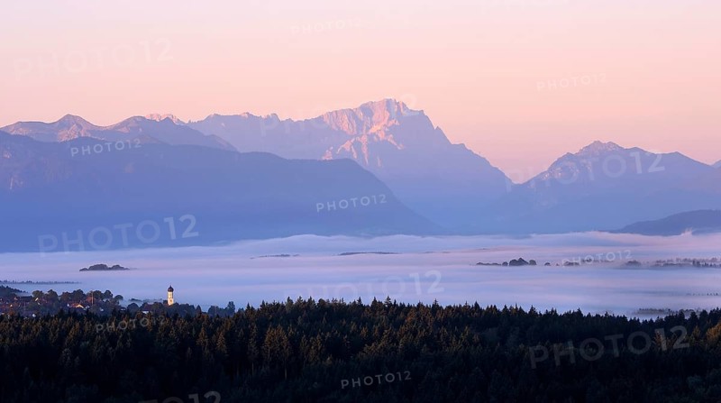 View from Peretshofener Hohe of Konigsdorf and the pre Alps to Zugspitze at sunrise