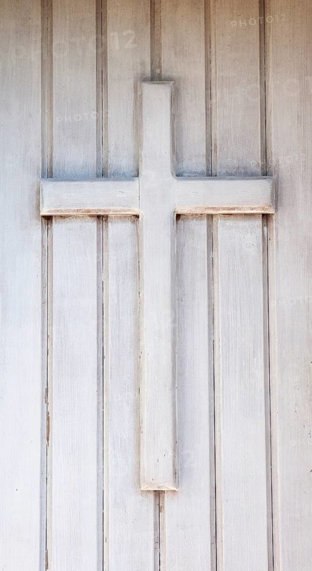 Wooden cross on the front door of a chapel