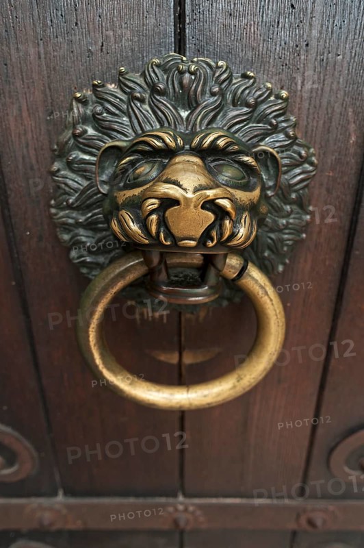 Lion head as a door knocker on the Romanesque entrance portal of the Scots monastery of St. Jacob
