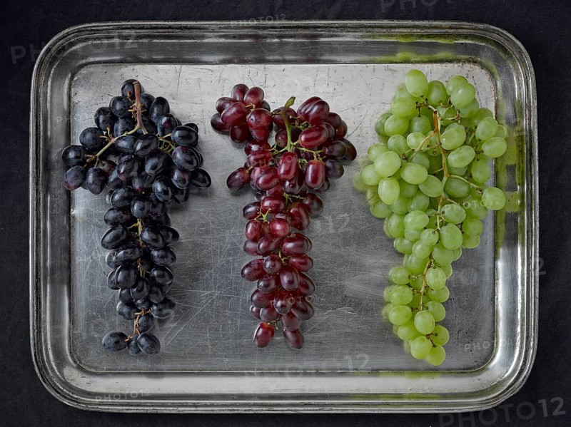 Three varieties of grapes on a silver platter