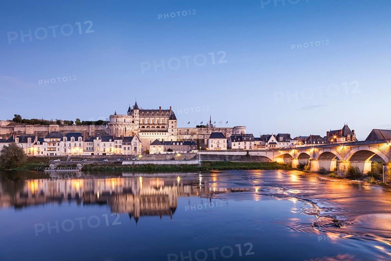 The walled town and Chateau of Amboise reflected in the River Loire in the evening