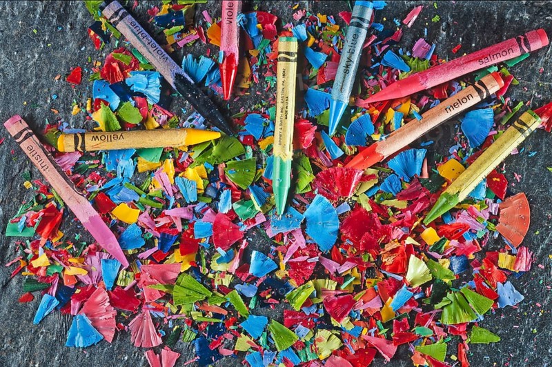 Colorful sharpened crayons on a slate