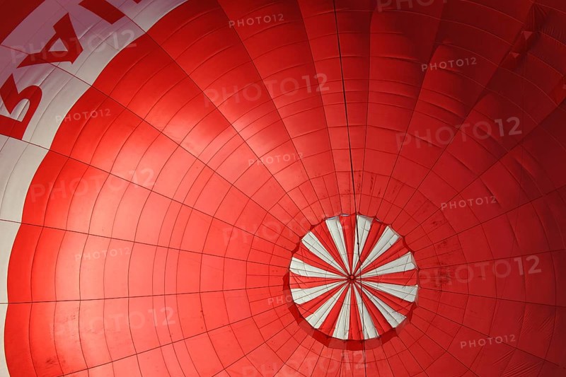 A red hot air balloon being inflated