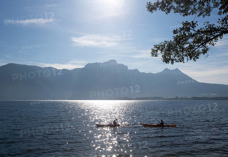 Canoeists on Lake Mondsee with Drachenwand and Schober