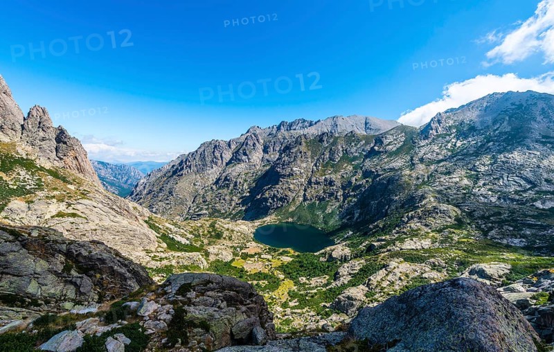 View on the mountain lake Lac de Capitello with surroundings