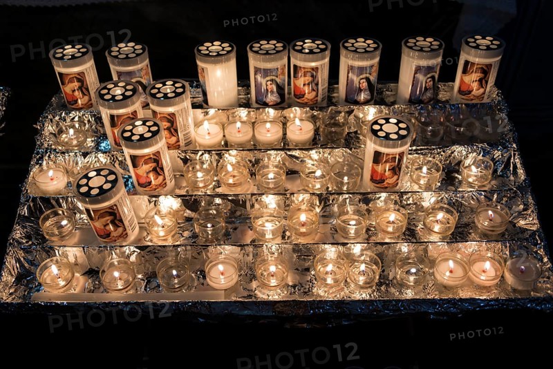 Burning votice candles in a church