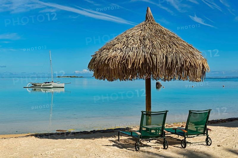 Parasol and sunloungers on the beach