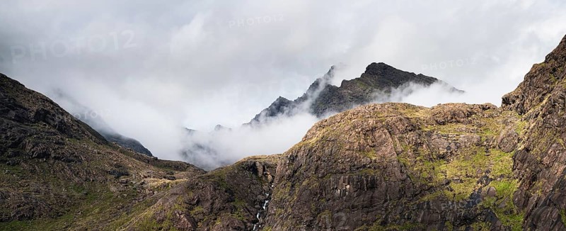 Allt a' Chaoich waterfall with peaks of Sgurr Dubh Beag and Sgurr Dubh Morr of Cuillin Hills behind