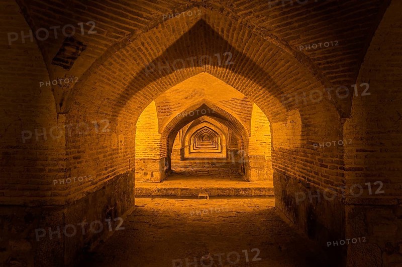 Arches under the illuminated Si-o-se Pol Bridge or Allah-Verdi Khan Bridge