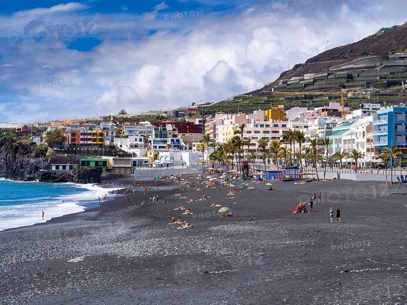 Tourists on the black beach of Puerto Naos