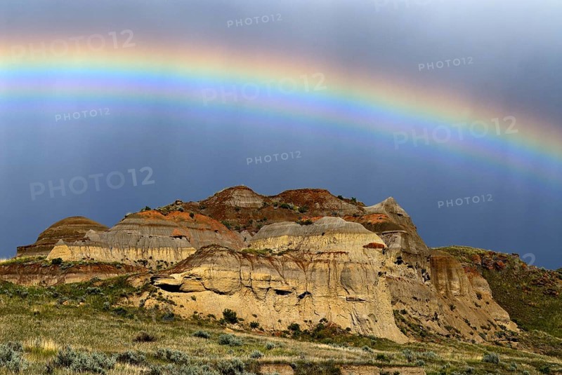 Rainbow over colorful badlands
