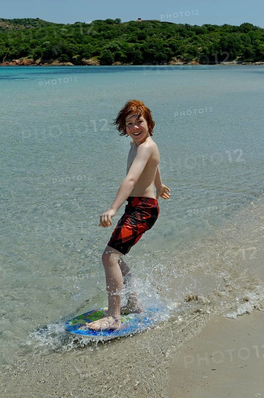 Boy surfing with his boogie board