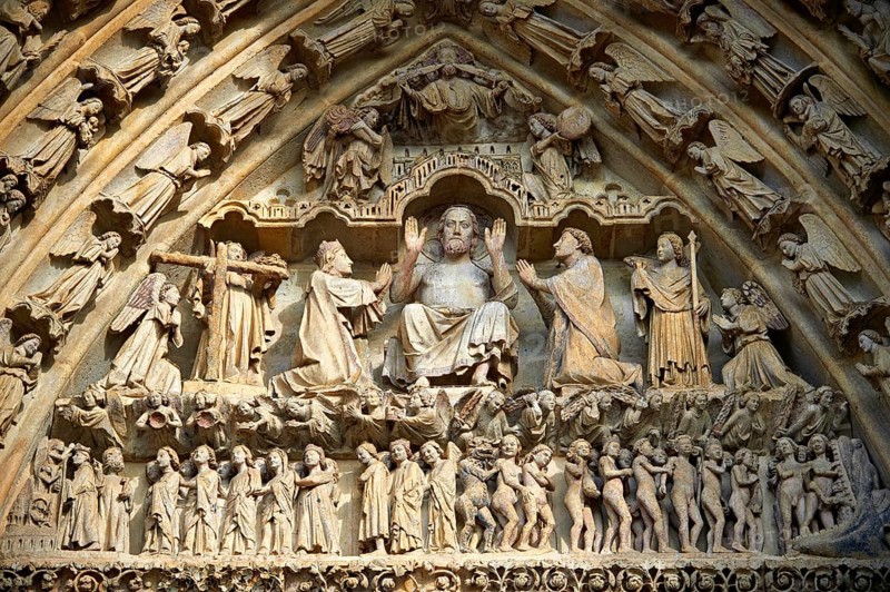 Tympanum of the central west portal showing Gothic sculptures of Christ in Majesty presiding over the Day of Judgement