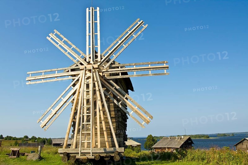 Old wooden windmill and houses