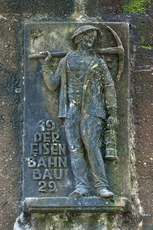 Man holding a pickaxe and a lamp