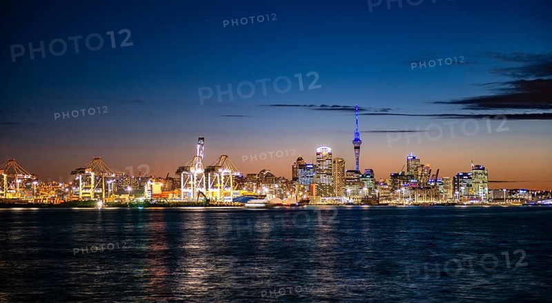 Illuminated skyline of Auckland at sunset
