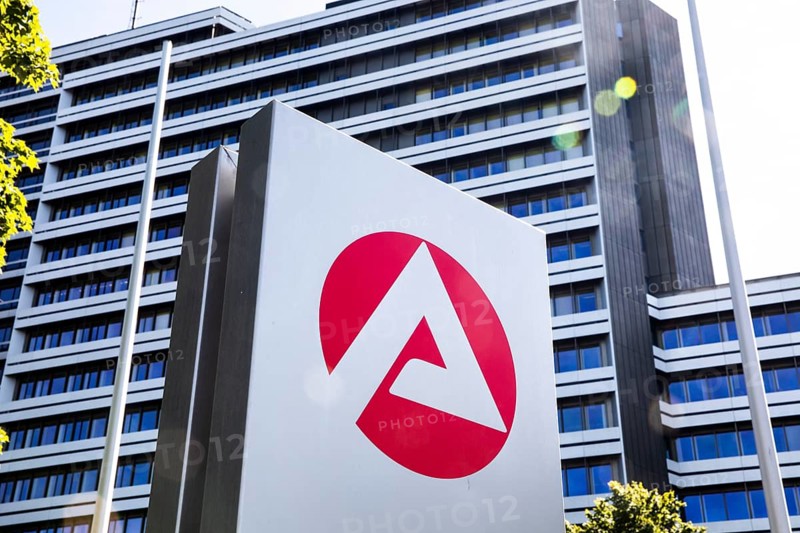Sign with logo in front of Federal Employment Agency