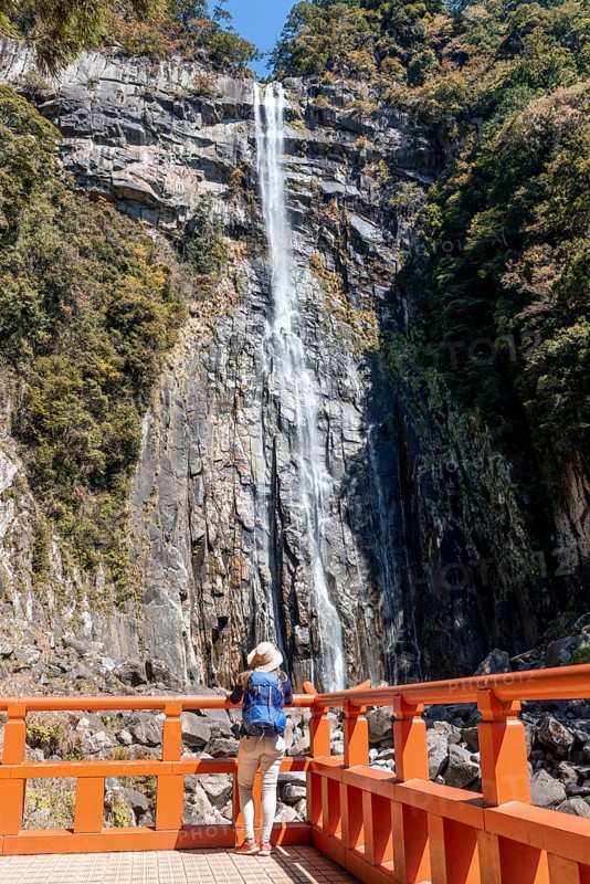 Tourist looks at Nachi Waterfall at Seigantoji Temple