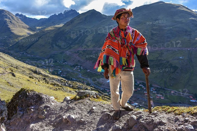 Indio mountain guide with hat and poncho in the Andes