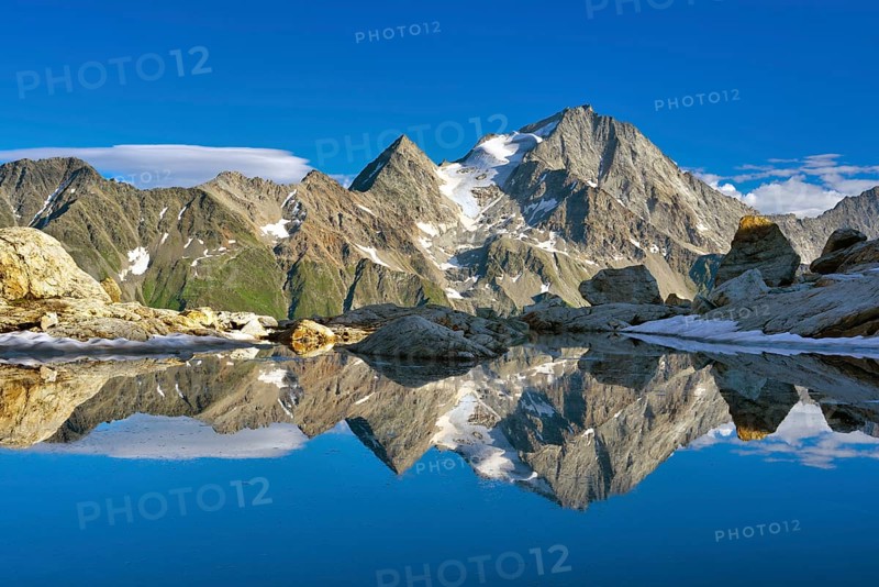 Reflection of the Oberalpstock in a mountain lake