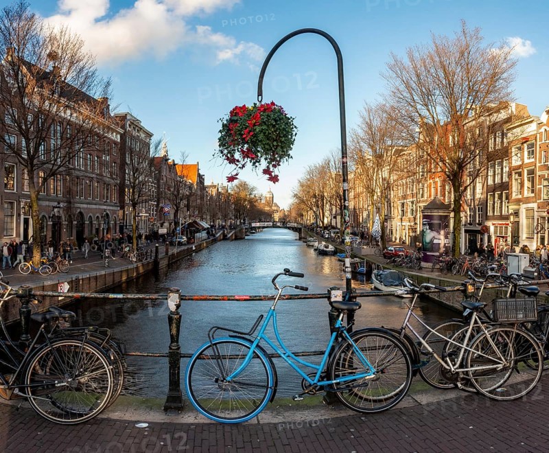 Parking bicycle on bridge over canal at Oudezijds Voorburgwal
