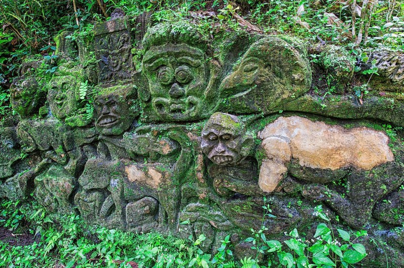Moss-covered sculpture in the forest