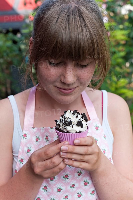 Girl looking at a homemade Oreo brownie cupcake