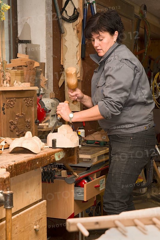 Young farmer carving traditional masks