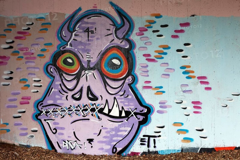 Monster with horns and mouth sewn shut