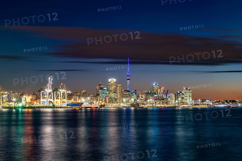 Illuminated skyline of Auckland at sunset