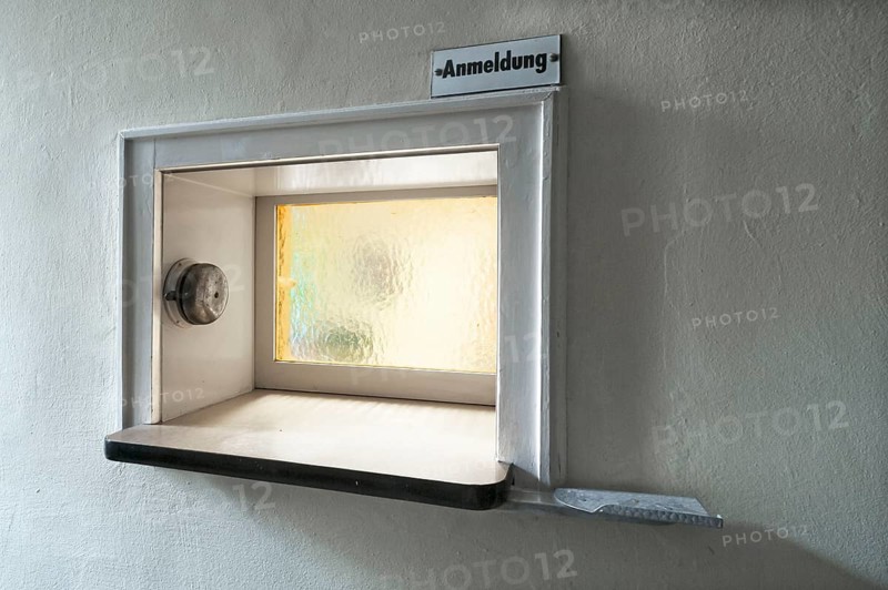 Former front desk with window and bell at an industrial plant