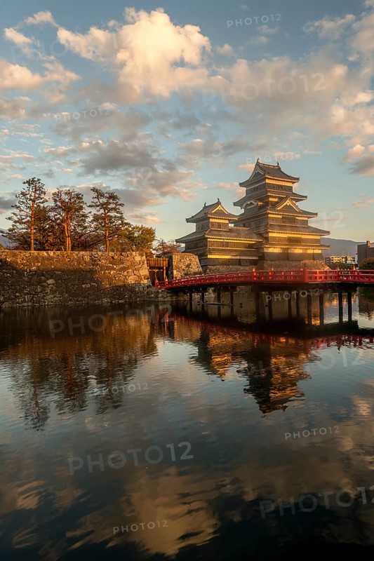 Japanese castle Matsumoto with reflection in the moat