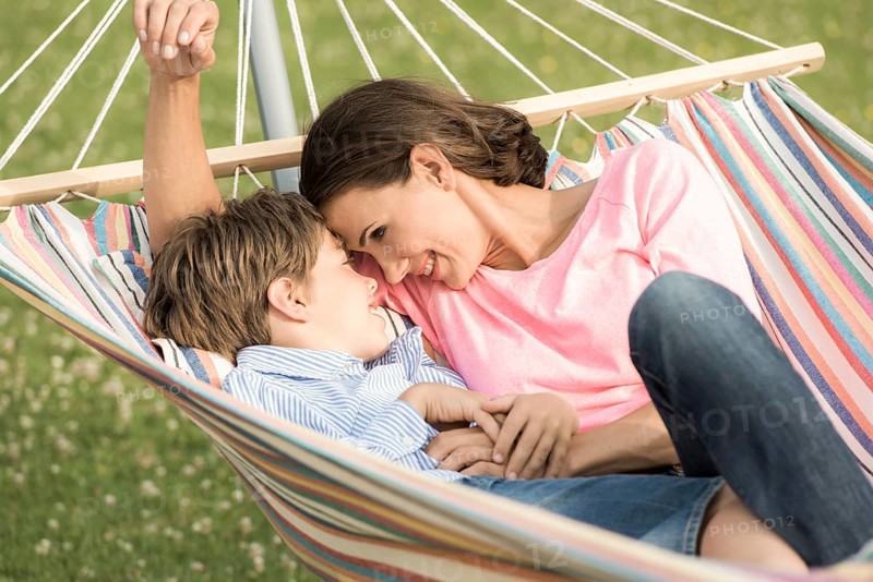 Mother and son lying in hammock