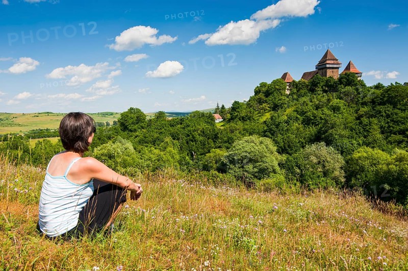 Woman looking at the fortified Saxonian church