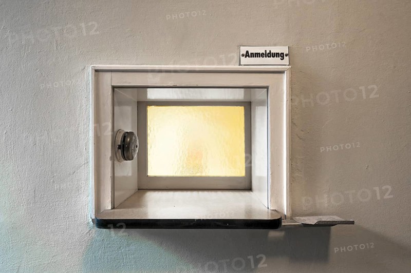 Former front desk with window and bell at an industrial plant