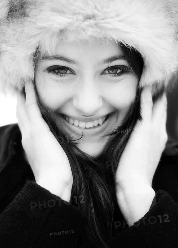 Smiling young woman wearing a fur hat