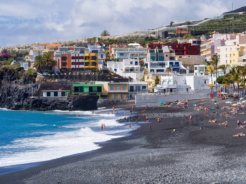 Tourists on the black beach of Puerto Naos