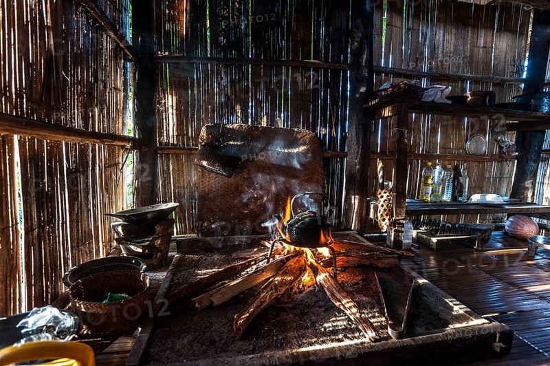 Kettle over an open fire in a kitchen made of bamboo