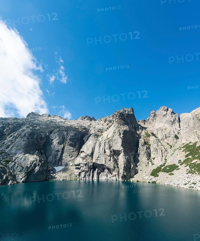Mountain lake Lac de Melo surrounded by cliffs