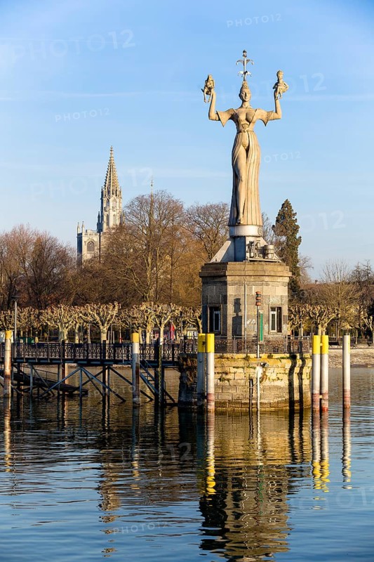 Statue of Imperia at the harbour of Konstanz with Konstanz Cathedral behind