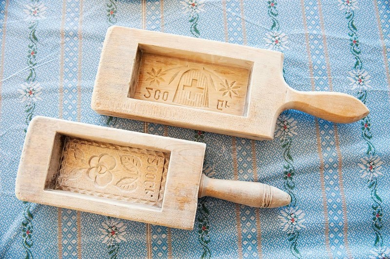 Two wooden butter moulds with carvings