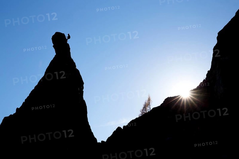 Climber on a cliff in the evening light at Savoy Alps